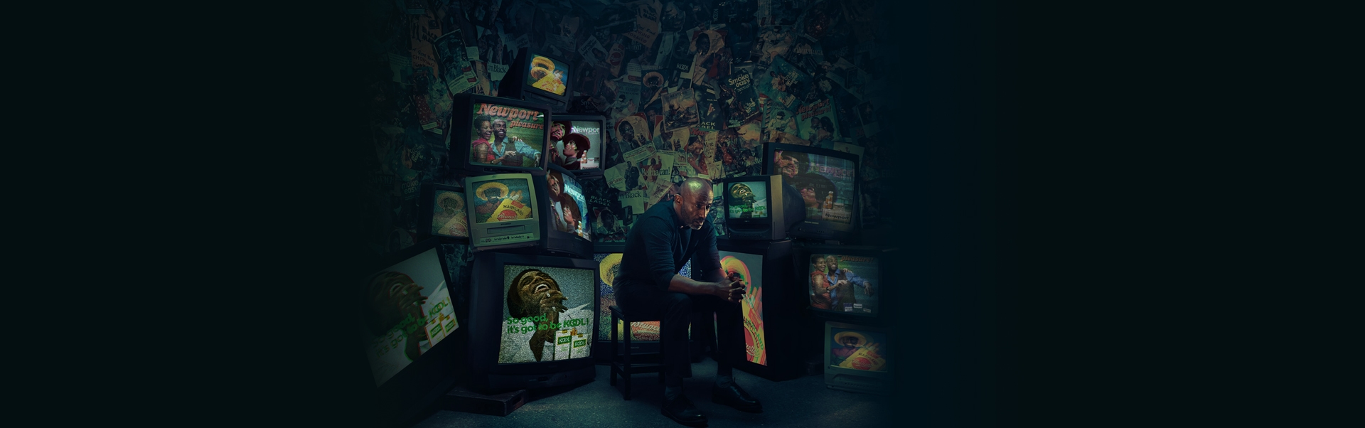 An African American/Black man sitting on a chair watching cigarette ads