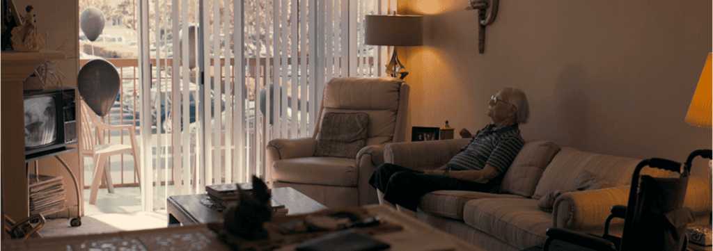 Man watching TV sat on a couch