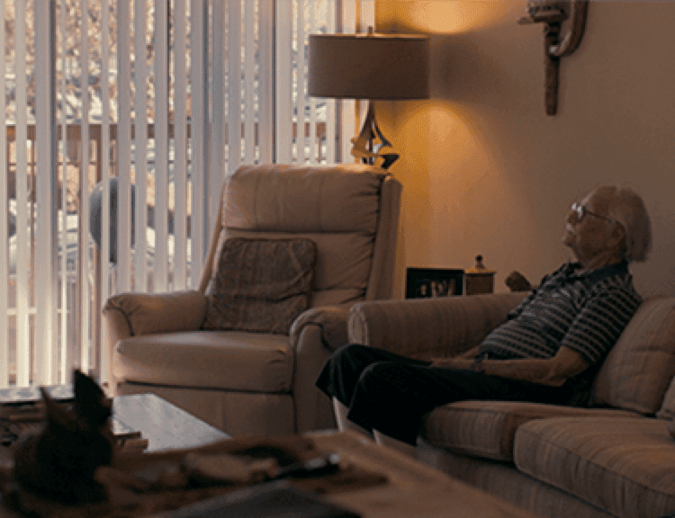 Man watching TV sat on a couch