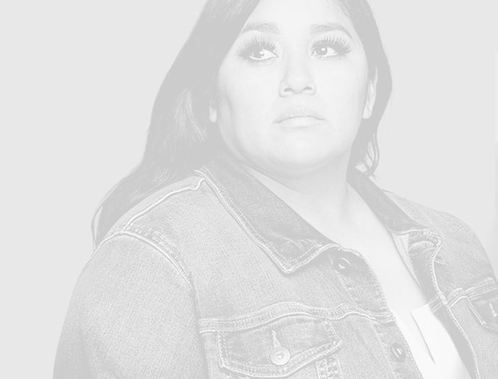 A black and white portrait of a woman wearing a jean jacket