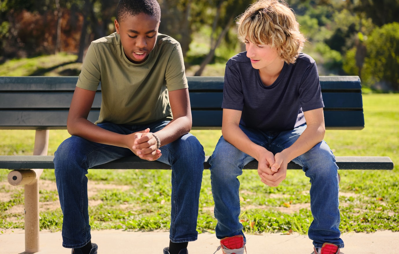 two kids on a park bench