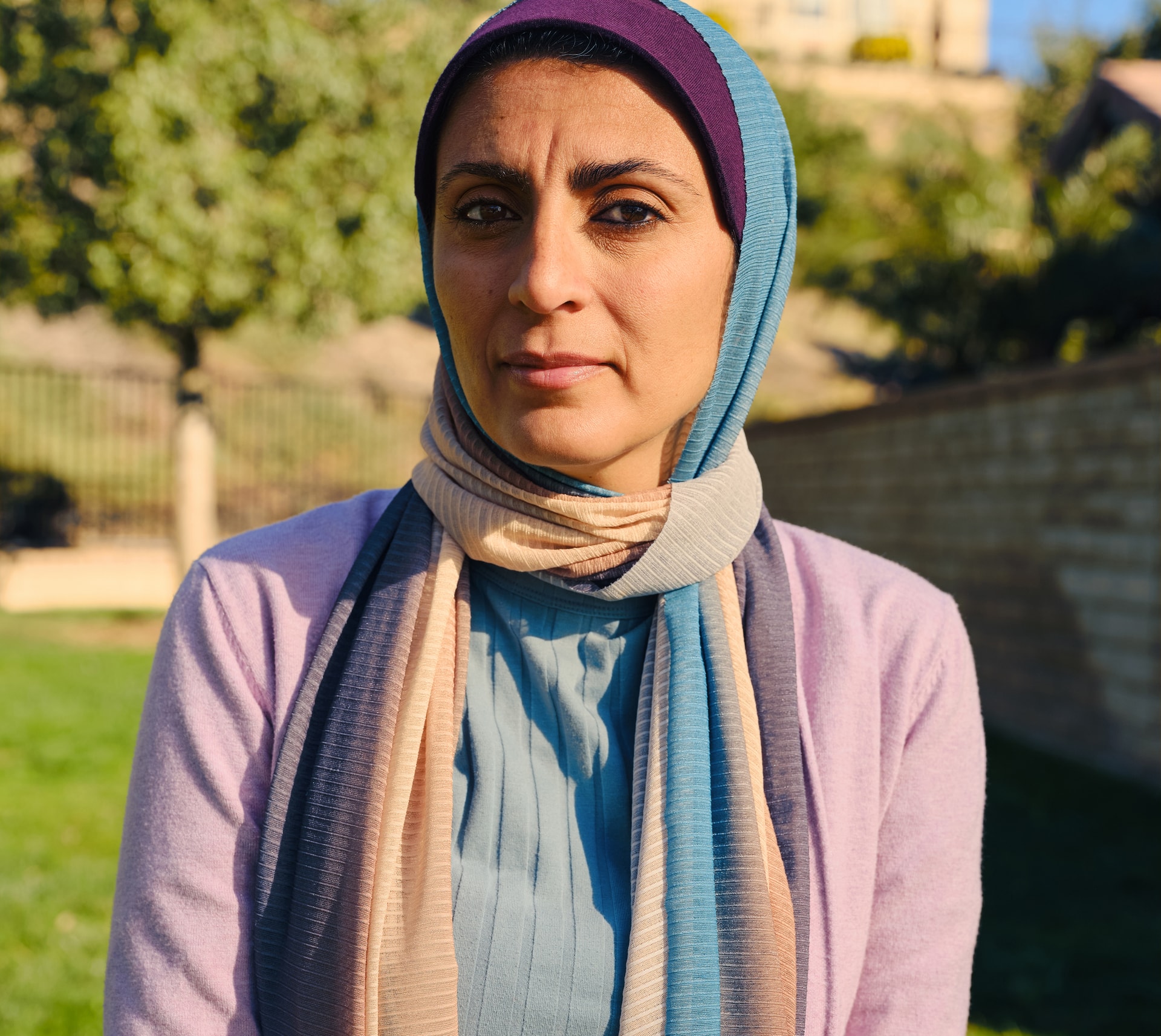 lady in a garden wearing a head scarf