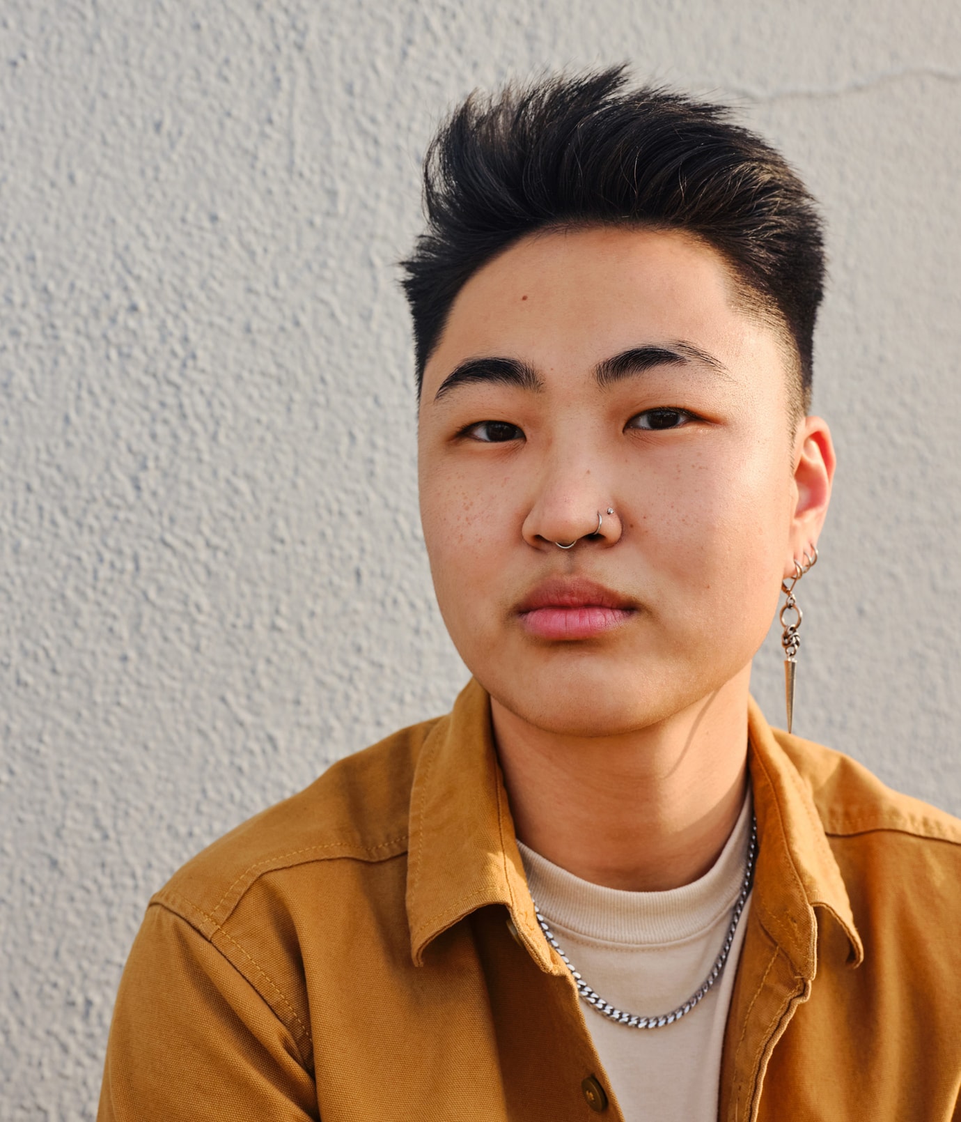 Solo image of young person in a mustard shirt