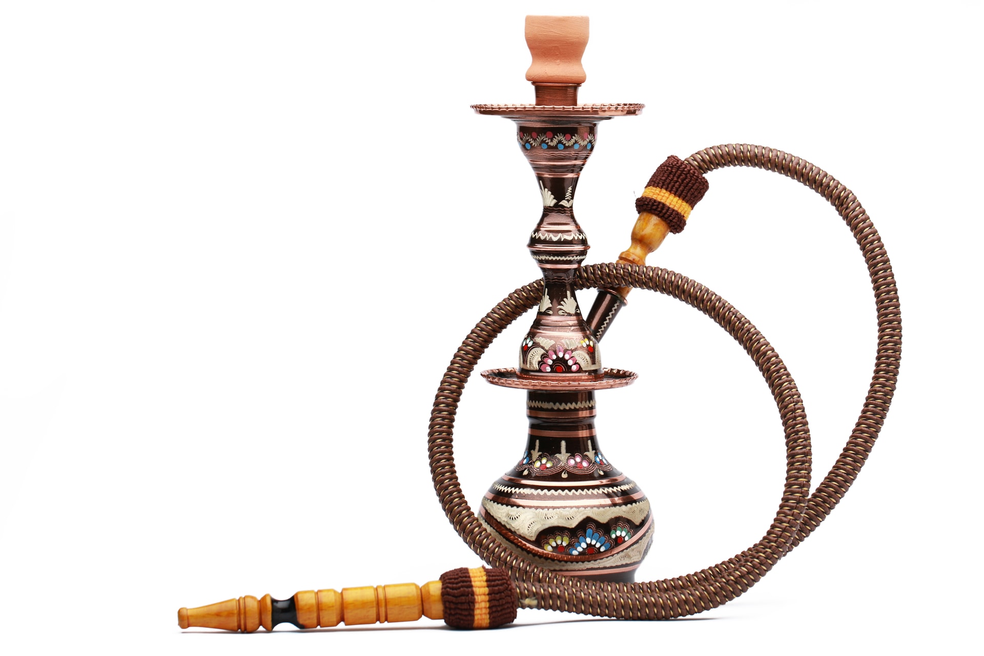 A copper hookah with its breathing hose artfully curled