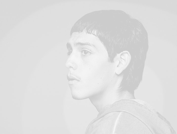 A black and white portrait of a young man