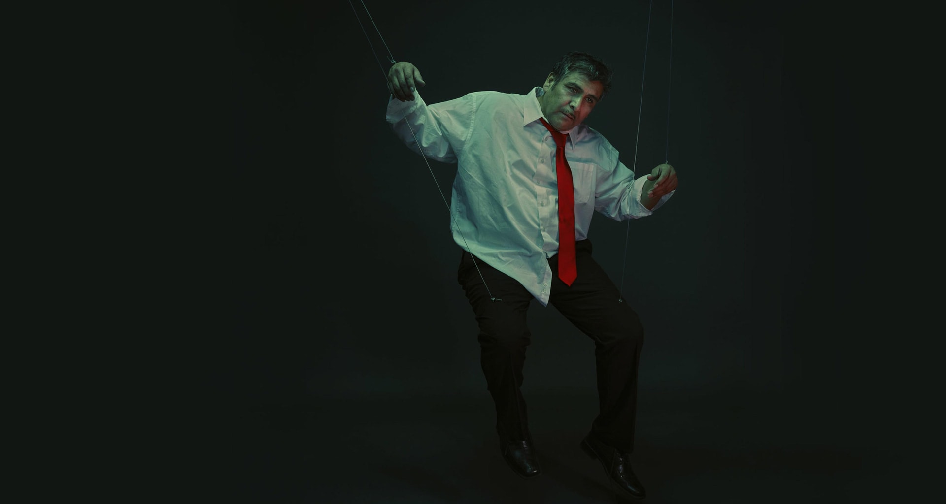 A Hispanic/Latino man as a puppeteer