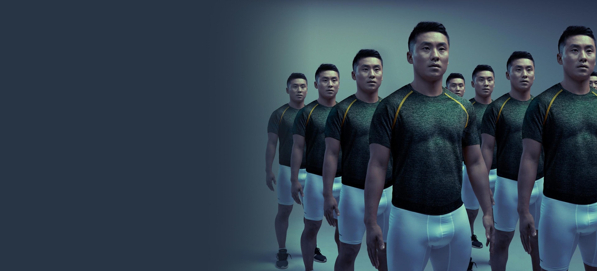 An Asian/Pacific Islander man with clones of him standing next to each other in a dark background