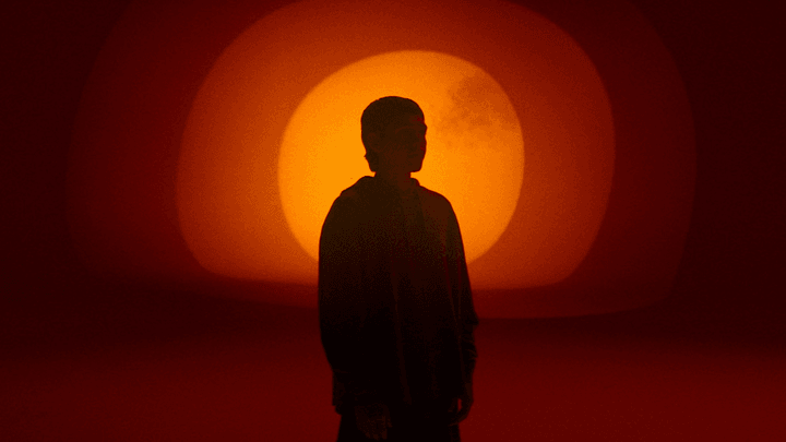 Silhouette of a person in a red ambient background