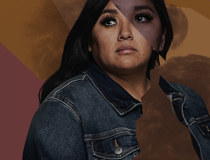 A black and white portrait of a woman wearing a jean jacket