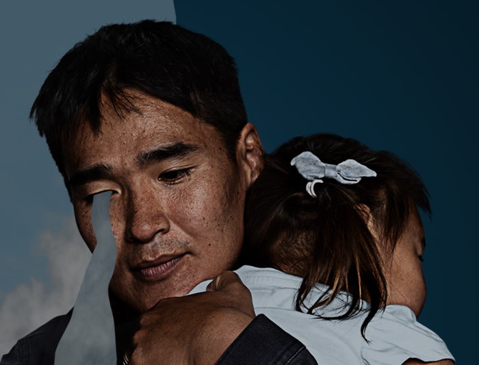 Man holding child crying - asian