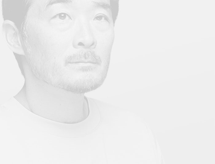 A black and white portrait of an Asian man