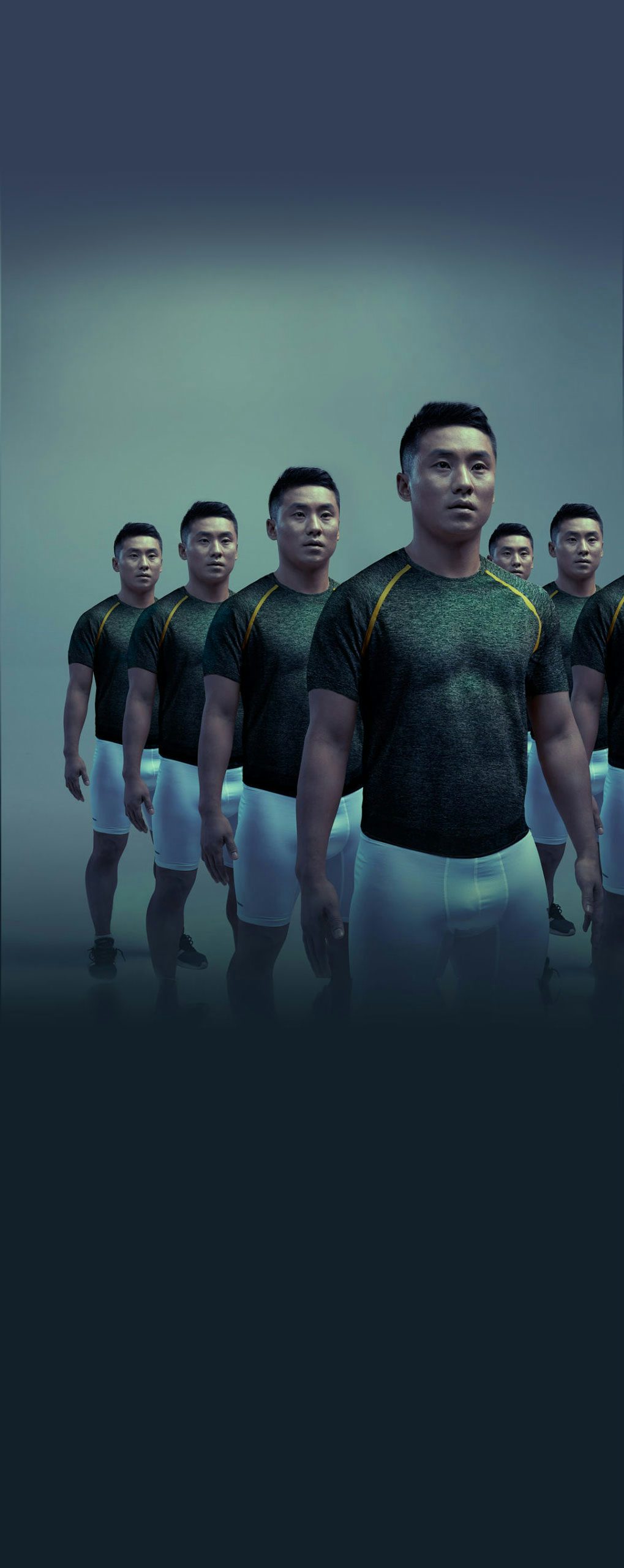 An Asian/Pacific Islander man with clones of him standing next to each other in a dark background