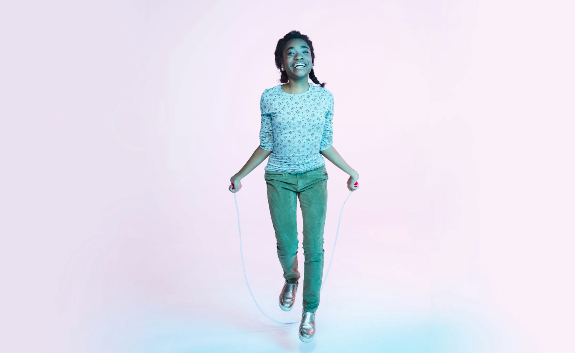 An African American/Black teen girl playing jump rope