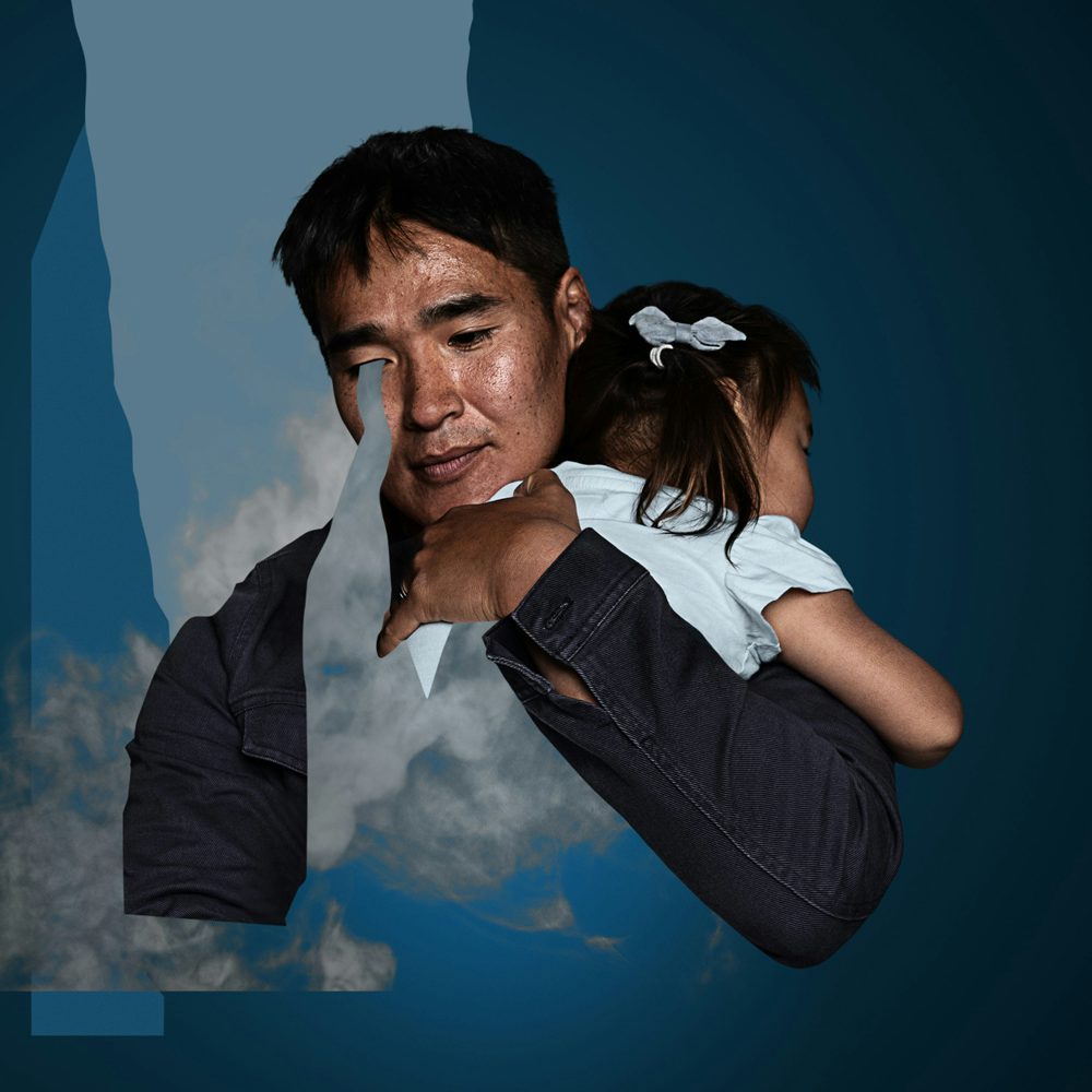 A man carrying his daughter over his shoulders
